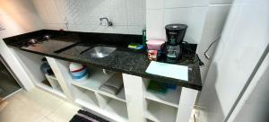 a small bathroom with a sink in a room at Apartamento 04 Centro de Igrejinha in Igrejinha +21 photos