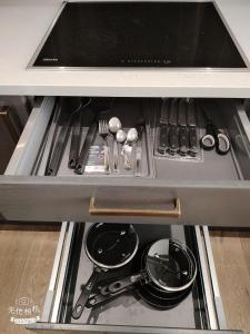 a drawer in a kitchen with some utensils at Spacious 2 bedroom flat by the Tower in London +12 photos