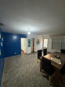 a room with a table and chairs and a blue wall at Casa BUENOS AIRES in Villa María