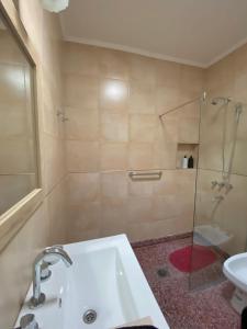 a bathroom with a sink and a shower with a glass door at N&G Alquiler Temporal in Venado Tuerto +5 photos
