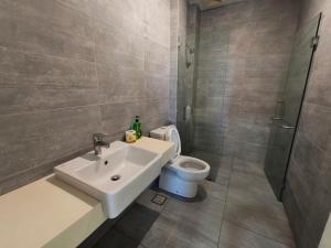 a bathroom with a sink and a toilet at Riverine Diamond 7 RDB Studio CK - Free 1 Parking, Netflix & Cozy Retreat Couples, Families in Kuching +30 photos