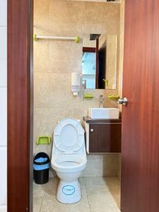 a bathroom with a toilet and a sink at Azotea Suites & Apartments in Cuenca +65 photos
