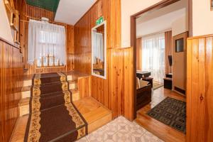 a room with wood paneled walls and a bathroom at O. W. Jodełka in Łeba