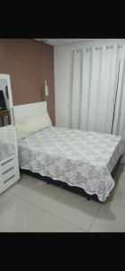 a bedroom with a bed with a white comforter at Ap mobiliado reg central de São Paulo in São Paulo +18 photos