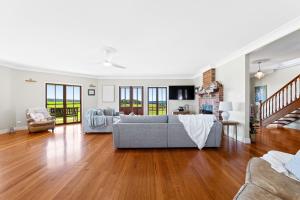 a living room with a couch and a table at 58 Mystery Bay Road, Mystery Bay in Central Tilba