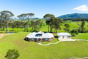 an aerial view of a large house in a field at 58 Mystery Bay Road, Mystery Bay in Central Tilba