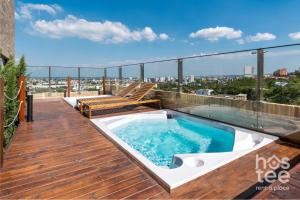 a deck with a hot tub on top of a building at H201 I Luxury Loft I Central I Balcony With Views in Cali +36 photos