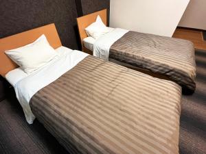 Postel nebo postele na pokoji v ubytování Itoen Hotel Shima