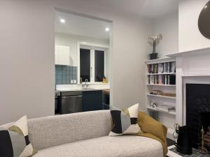 a living room with a couch and a fireplace at Discerning in Thorndon in Wellington +15 photos