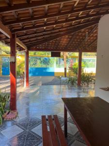 a patio with a wooden bench and a table at Recanto da Vovó in Santarém
