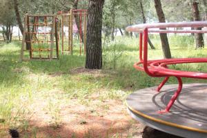 a park with a playground with a red bench at Il Praedio Della Reale in Ginosa