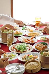 a table full of plates of food on a table at ANA Holiday Inn Kanazawa Sky by IHG in Kanazawa