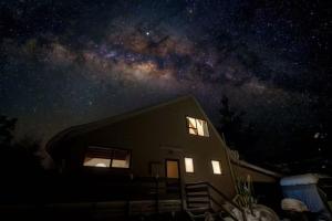a house at night with the milky way at Murray's Forest Rest in Lake Tekapo +7 photos