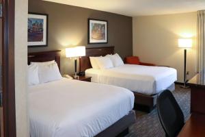 a hotel room with two beds and two lamps at Mustang Inn in Paducah