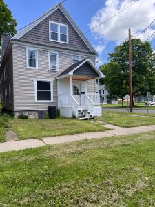 een huis aan een straat met een stoep bij Finger Lakes Apartment in Hornell
