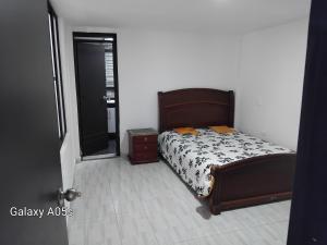 a bedroom with a bed and a mirror and a door at Villa kari in Palestina +15 photos