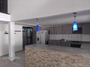 a kitchen with blue lights hanging from the ceiling at Villa kari in Palestina