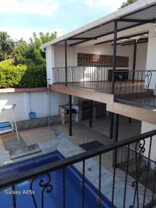 a house with a balcony and a swimming pool at Villa kari in Palestina