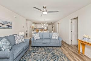 a living room with a couch and a table at Serenity is Yours Oceanfront Pool SP2 in Myrtle Beach