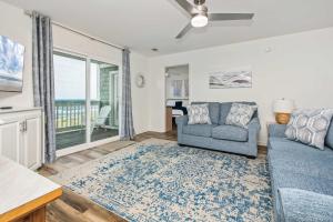 a living room with a couch and a chair at Serenity is Yours Oceanfront Pool SP2 in Myrtle Beach