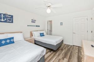 a bedroom with two beds and a ceiling fan at Serenity is Yours Oceanfront Pool SP2 in Myrtle Beach +78 photos