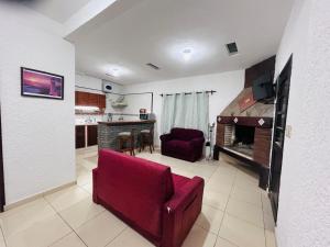 a living room with a couch and a fireplace at A pasitos del mar in La Coronilla