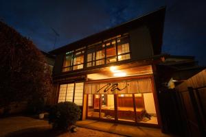 a building with a sign in the window at night at Hotel TEN in Yuki