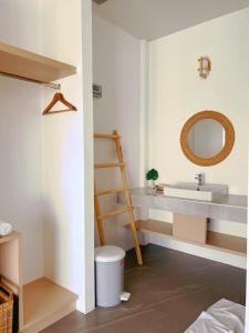 a bathroom with a sink and a mirror at Longlay Resort Rayong ล่องเล รีสอร์ท ระยอง in Ban Tha Fat