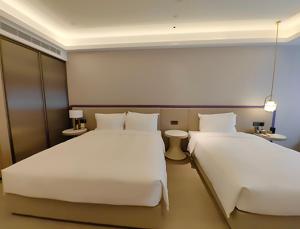 Rúm í herbergi á Xi'an Jinling Purple Mountain Hotel