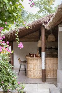 an outdoor kitchen with a table and a chair at Golden Garuda Cottages at Diamond Beach Hills in Nusa Penida