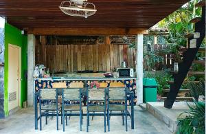 a kitchen with a table with chairs and a bar at Gumpor Art Studio in Chiang Rai