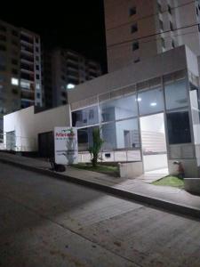 a building with large glass windows on a city street at Mirador de la estancia in Melgar +10 photos