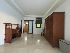 an empty living room with wooden furniture and a room at Charming Jungle Home in Chaweng in Amphoe Koh Samui