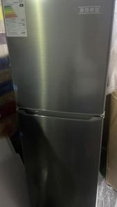 a stainless steel refrigerator sitting in a kitchen at Residencia en Gourmancia - Estancia & Sabor in Puno