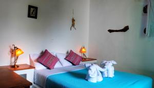 two stuffed elephants sitting on a bed in a room at Pano Gitonia in Aegiali