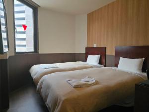 Postel nebo postele na pokoji v ubytování Hotel Ekichika Nagahoribashi