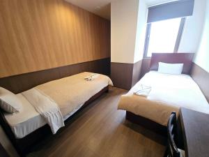 Postel nebo postele na pokoji v ubytování Hotel Ekichika Nagahoribashi