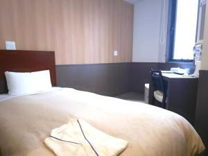 Postel nebo postele na pokoji v ubytování Hotel Ekichika Nagahoribashi