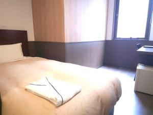 Postel nebo postele na pokoji v ubytování Hotel Ekichika Nagahoribashi