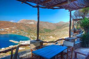 a blue bench sitting on top of a house at Pano Gitonia in Aegiali