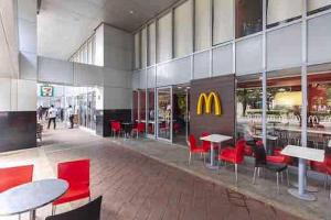 a mcdonalds restaurant with red chairs and tables at Mactan Newtown township staycation with pool access in Lapu Lapu City