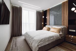 Giường trong phòng chung tại Noviy Bereg Luxury Apartment