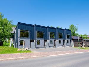 a blue building on the side of a street at Minn house Niseko Hirafu in Kutchan
