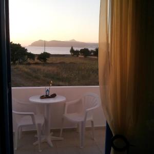 a table and chairs with a view of the ocean at Vigles in Adamantas
