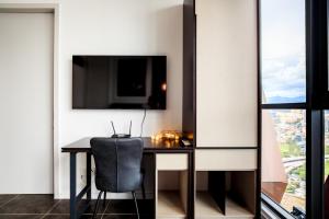 a dining room with a table and a chair at Luxury Scarletz Suites KLCC in Kuala Lumpur +41 photos