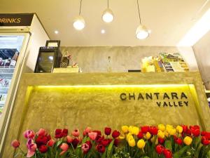 a sign in a store with red and yellow tulips at Chantara Valley Resort in Mu Si +201 photos