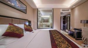 a bedroom with a large white bed with red pillows at Nanning Yongjiang Hotel in Nanning