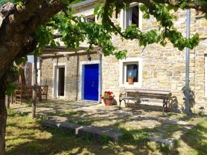 a stone building with a blue door and a bench at Istrian House in Portorož +29 photos