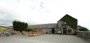 a stone building with bikes parked in front of it at Ystumgwern Luxury Barn Conversions in Dyffryn