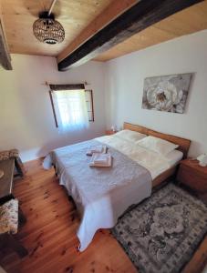 a bedroom with a large bed with a tray on it at Rustic home Mia in Duga Resa